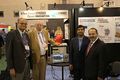 The photo is taken in June 2018 at IEEE International Microwave Symposium Exhibition Booth, Dr. Rohde is showing the world-best OEO (Tunable Ka-Band Synthesizer using Opto-Electronic circuits) at his company Synergy Microwave booth to IEEE AP-S President Prof. Ahmed Kishk-standing first from right and Prof. Tapan Sarkar first from left, Dr. Ulrich Rohde is standing second from the left.
